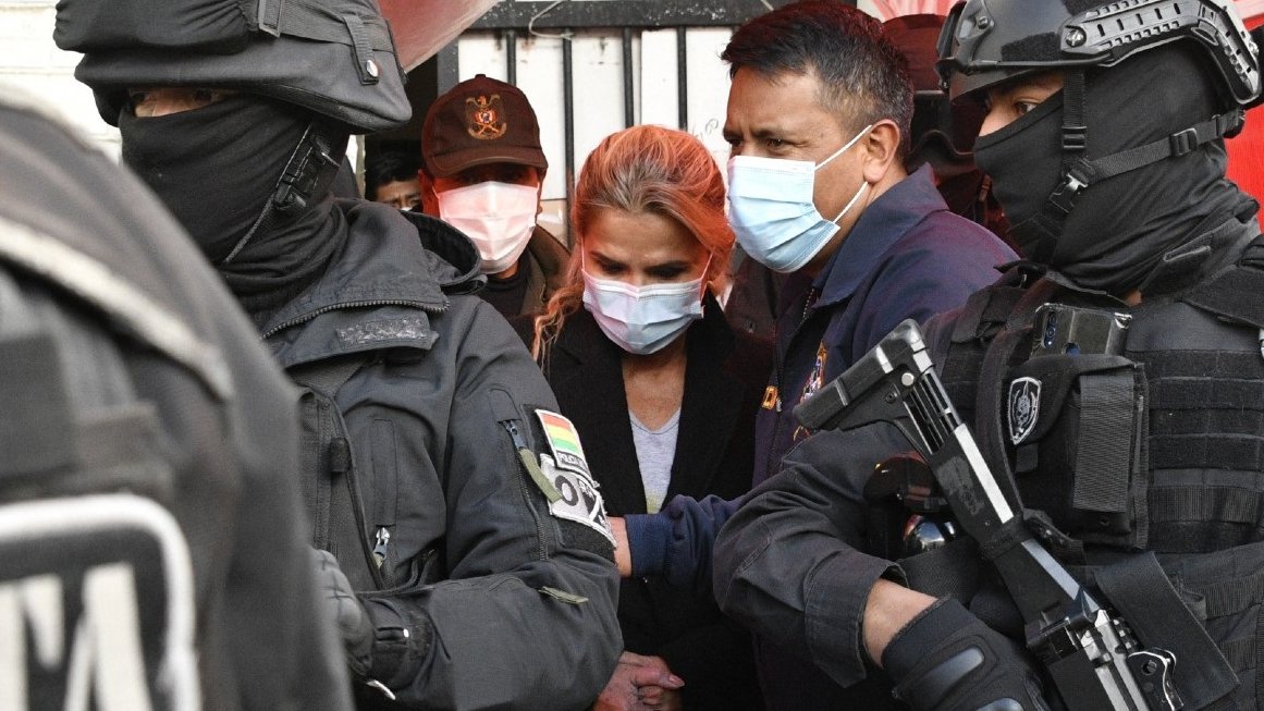 Jeanine Áñez es escoltada por miembros de la policía de la Fuerza Especial contra el Crimen FELCC tras ser arrestada en La Paz