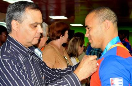 El entonces vicepresidente del Inder, Osvaldo Vento impone la Medalla de la Dignidad al pesista Yoelmis Hernández